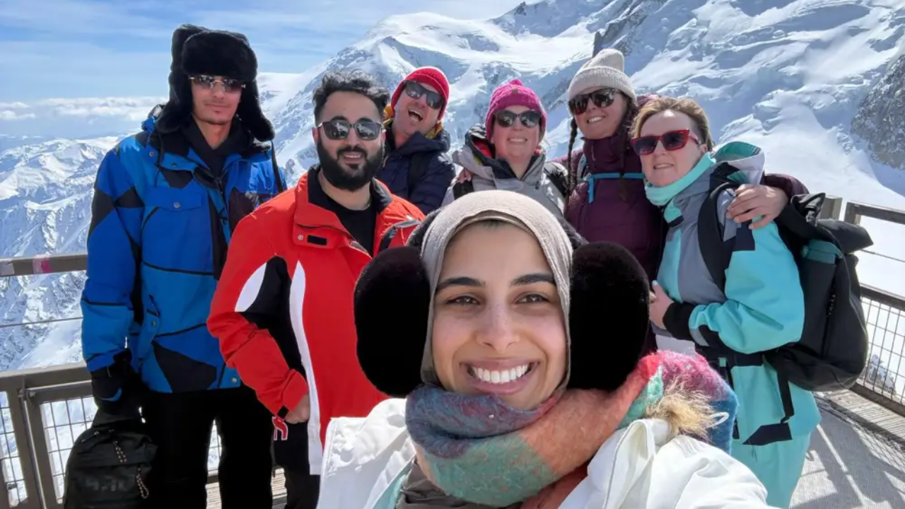 Delegates together at altitude above Chamonix with Mont Blanc behind